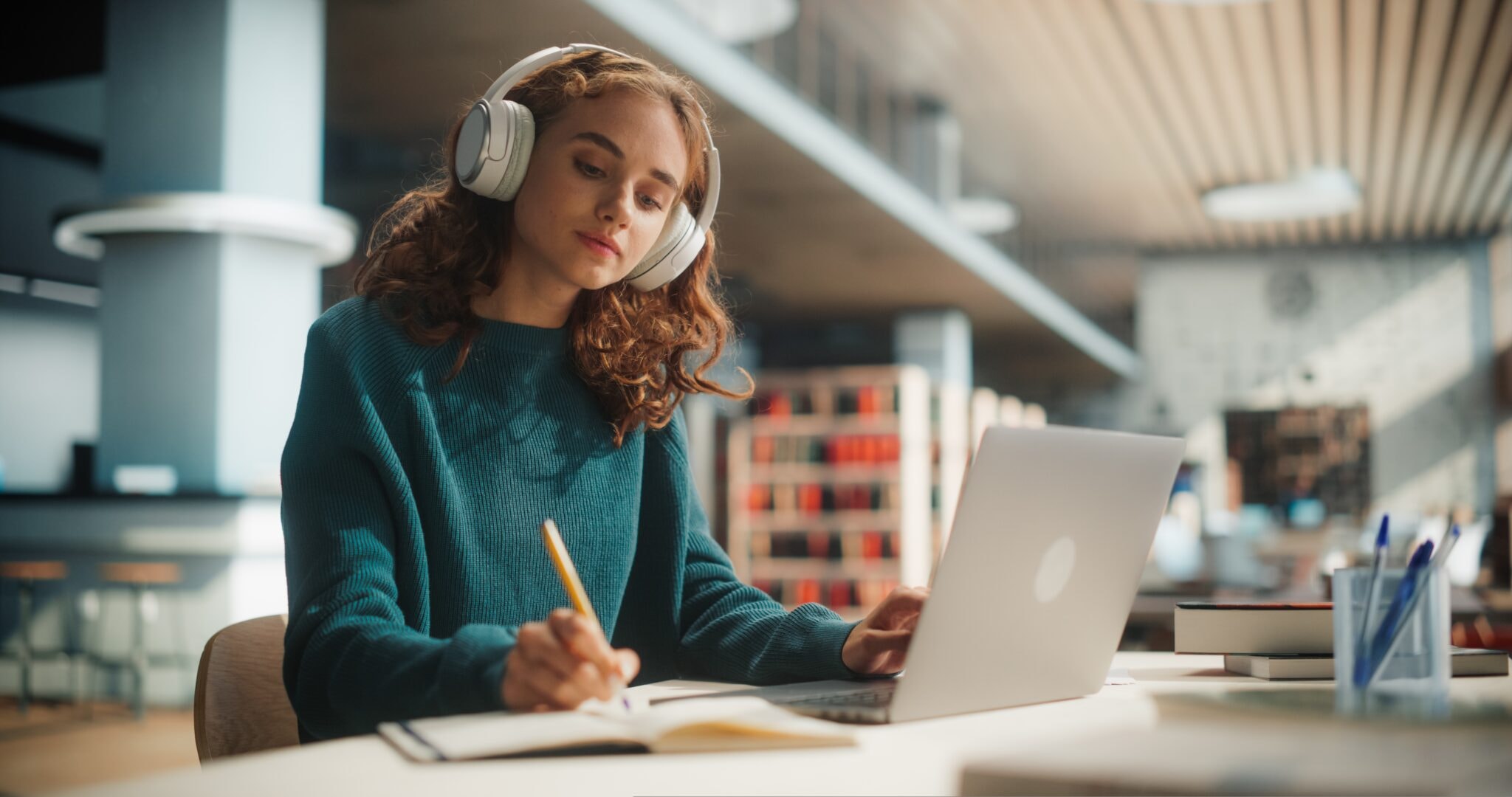 Concentrated,Young,Female,Student,Engaged,In,Academic,Research,With,Laptop