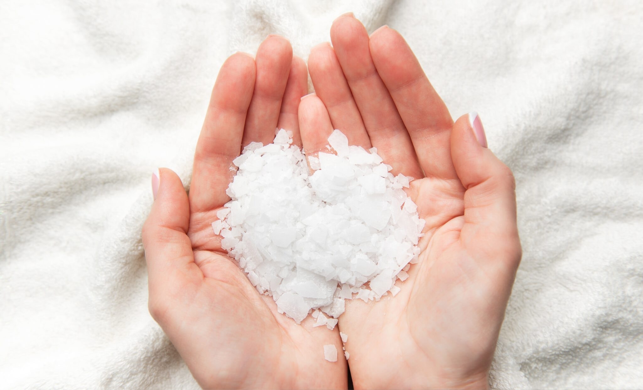 Woman,Gently,Holding,Magnesium,Chloride,Flakes,,Preparing,For,A,Therapeutic
